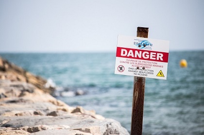 Panneau d'alerte de la présence d'une digue sur une plage