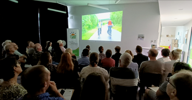 A group of people in a room watching a presentation

AI-generated content may be incorrect.